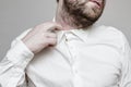 The unshaven man in the white shirt is tight and stuffy Royalty Free Stock Photo