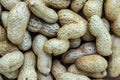 Unshelled brown peanuts background