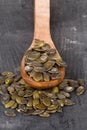 Unshelled pumpkin seeds in wooden spoon Royalty Free Stock Photo