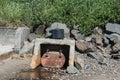 Unsightly drainage ditch placed on the shoreline of the Pacific Ocean