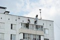 unskilled labor - migrant workers work on high-rise work on the roof of a house in Moscow Royalty Free Stock Photo