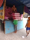 The unskilled workers in the market are lifting 25 kg of rice, as much as 4 sacks of rice.