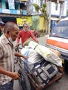 Port workers carry goods from the port to the new Kampung Ulu terminal, Balikpapan, Indonesia