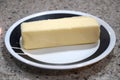 Stick of butter unsliced on a plate Royalty Free Stock Photo