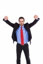 Unsmiling businessman standing with arms raised