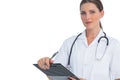 Unsmiling nurse holding clipboard and looking at camera Royalty Free Stock Photo