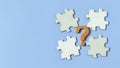 Unsolved Problem or Missing Piece concept with a question mark and four jigsaw puzzle pieces, symbolizing a search for answers and Royalty Free Stock Photo