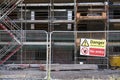 Unstable building keep out dangerous sign on fence at building construction site Royalty Free Stock Photo