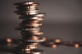 Unstable stack of euro coins close-up with blurred background