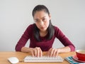 Unstatisfied and serious woman working on her desk.