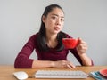 Unstatisfied and serious woman working on her desk.