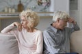 Serious older couple thinking about divorce seated on sofa Royalty Free Stock Photo