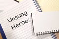 Unsung heroes write on notebook Royalty Free Stock Photo