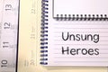 Unsung heroes write on notebook Royalty Free Stock Photo