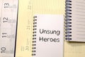 Unsung heroes write on notebook Royalty Free Stock Photo