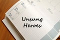 Unsung heroes write on notebook Royalty Free Stock Photo