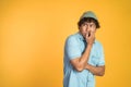 unsure asian young man thinking on isolated background