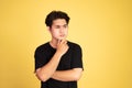 unsure asian young man wearing black shirt Royalty Free Stock Photo