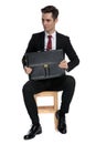 Unsure businessman holding his suitcase and looking away Royalty Free Stock Photo