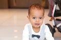 Unsure cute toddler boy in suit with bowtie