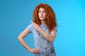 Unsure silly timid hesitant cute redhead curly-haired ginger girl frowning uncertain asking your opinion questioned look