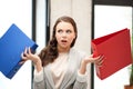 Unsure thinking or wondering woman with folder Royalty Free Stock Photo