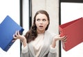 Unsure thinking or wondering woman with folder Royalty Free Stock Photo