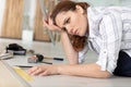 unsure woman measuring floor Royalty Free Stock Photo