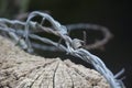 Untidy Barbed Wire On Fence Post Closeup