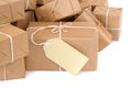 Pile of brown paper parcels or packages with manila label isolated on white