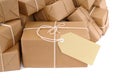 Untidy pile of brown paper parcels with manila label isolated on white background