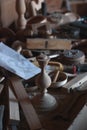 Untidy workplace in an old carpenter workshop with wood carpenter tools in the background, scattered vintage tools in a