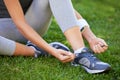 Untied shoelaces wont stop her workout. a runner tying her shoelaces.