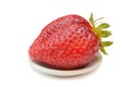 Giant strawberry on a plate Isolated on white background