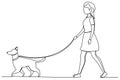 A woman in a short skirt walks casually with her dog