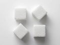 Four square sugar cubes arranged on a white background, top view. Royalty Free Stock Photo