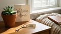 New Home Key Tag with Vintage Key and \'Welcome Home\' Card on Wooden Nightstand Royalty Free Stock Photo