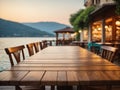 Empty wooden table top with blurred lakeside cafe on gorgeous lake, product display Royalty Free Stock Photo
