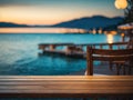 Empty wooden table top with blurred lakeside cafe on gorgeous lake, product display