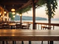 Empty wooden table top with blurred lakeside cafe on gorgeous lake, product display
