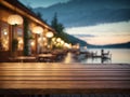 Empty wooden table top with blurred lakeside cafe on gorgeous lake, product display Royalty Free Stock Photo