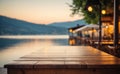 Empty wooden table top with blurred lakeside cafe on gorgeous lake, product display