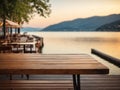 Empty wooden table top with blurred lakeside cafe on gorgeous lake, product display