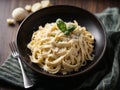 Fettuccine alfredo with parmesan cheese isolated on black background