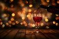 Pouring red wine in a glass on the wood table with night life background Royalty Free Stock Photo