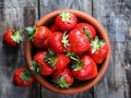 fresh strawberries in the bowl on the wooden table. Royalty Free Stock Photo