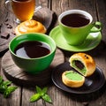 Coffee in green cups with cake on a wooden table Royalty Free Stock Photo