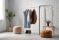Minimalist wardrobe features neutral tones, organized shelves, stylish rack, and natural light Royalty Free Stock Photo