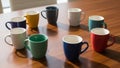 Colorful coffee mugs circle symbolizing teamwork and diversity Royalty Free Stock Photo