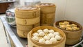 Bamboo steamers are stacked on a kitchen counter, each filled with different types of dim sum. Royalty Free Stock Photo